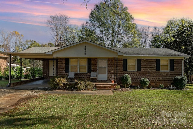 view of front of house with a carport and a yard