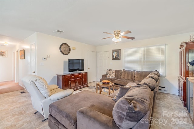 living room with ceiling fan and a baseboard heating unit