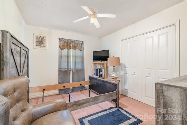 interior space with ceiling fan, light colored carpet, and a textured ceiling