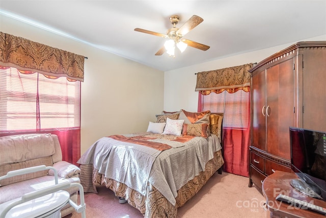 bedroom with ceiling fan and light carpet