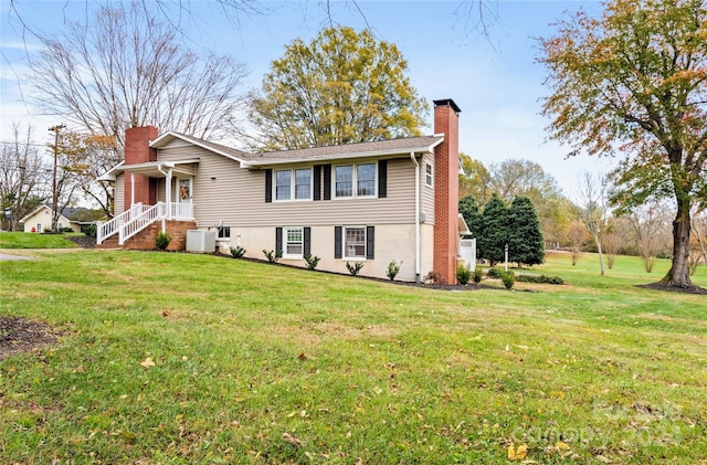 view of front of house featuring central AC and a front lawn