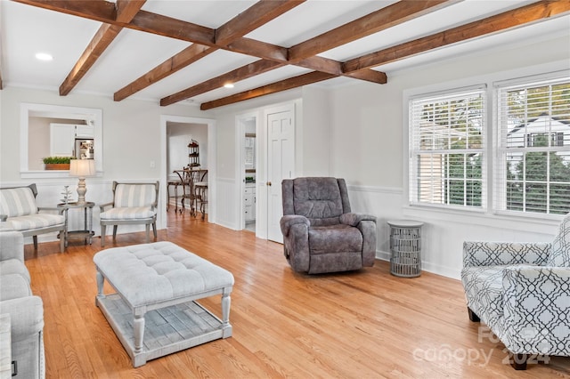 living room featuring beam ceiling, light hardwood / wood-style flooring, and coffered ceiling