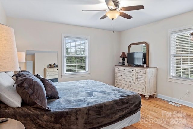 bedroom with light hardwood / wood-style floors and ceiling fan