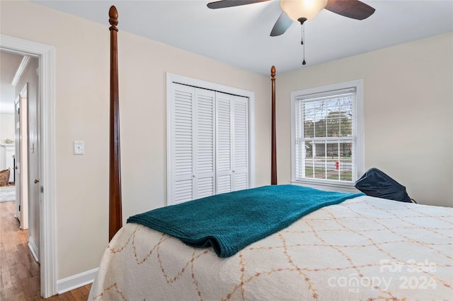 bedroom with hardwood / wood-style floors, a closet, and ceiling fan