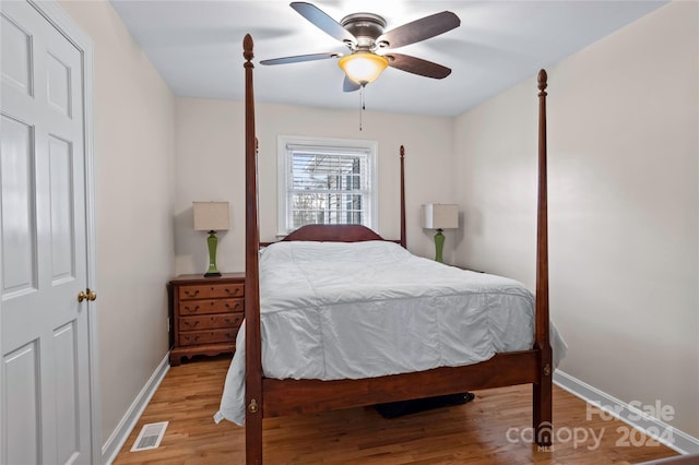 bedroom with ceiling fan and wood-type flooring