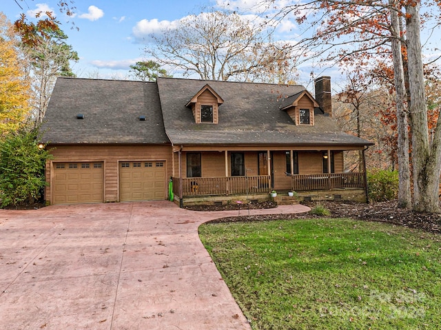 view of front facade with a garage, covered porch, and a front yard