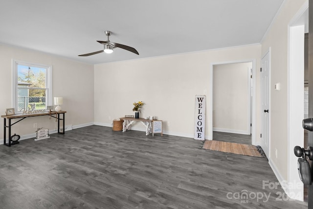 spare room with ceiling fan, ornamental molding, and dark wood-type flooring