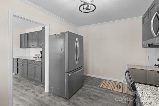 kitchen with dark hardwood / wood-style flooring, crown molding, and appliances with stainless steel finishes