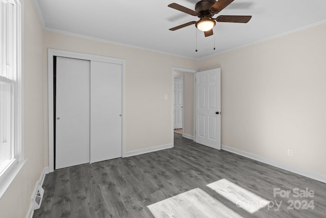 unfurnished bedroom with a closet, ceiling fan, hardwood / wood-style floors, and crown molding