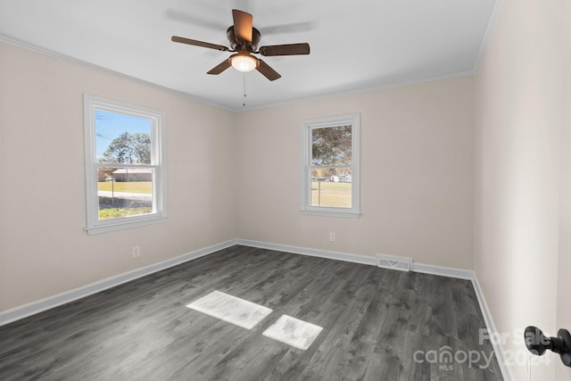 spare room featuring ceiling fan, ornamental molding, and dark wood-type flooring