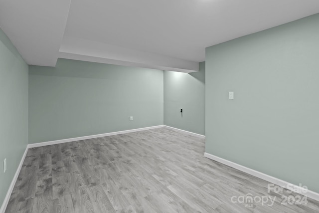 basement with light hardwood / wood-style floors