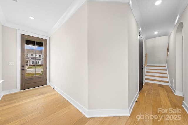 hall featuring crown molding and light wood-type flooring