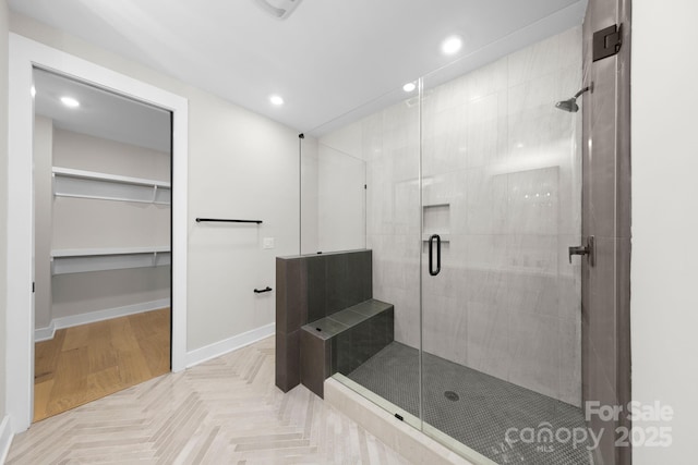 full bath with a shower stall, baseboards, a walk in closet, and recessed lighting