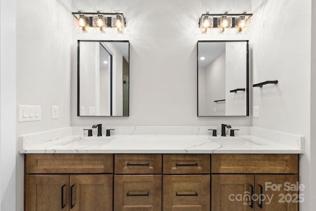 full bathroom with double vanity and a sink