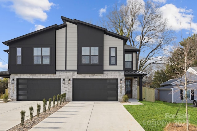 contemporary home featuring concrete driveway, a standing seam roof, a garage, stone siding, and a front lawn