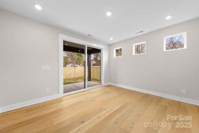 unfurnished room with recessed lighting, visible vents, baseboards, and wood finished floors