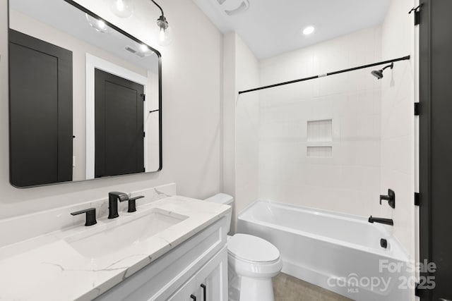 bathroom featuring washtub / shower combination, toilet, visible vents, and vanity