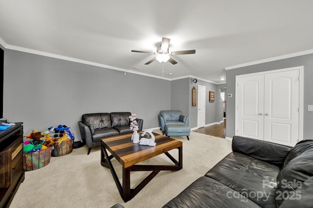 living room with ornamental molding, a ceiling fan, baseboards, and carpet floors