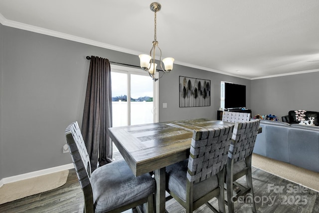 dining area with an inviting chandelier, wood finished floors, baseboards, and ornamental molding