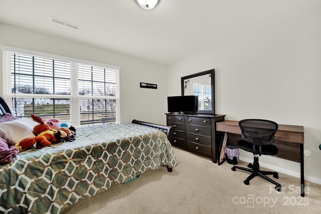 bedroom with visible vents, baseboards, and light colored carpet