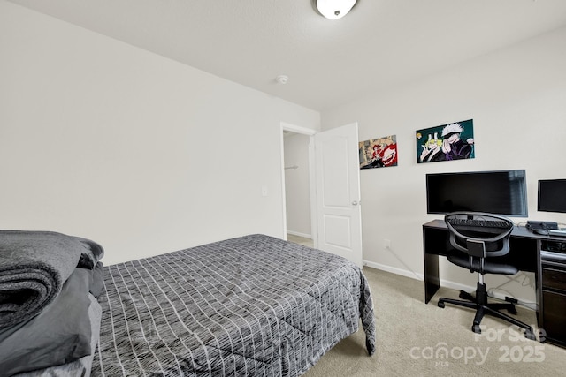 bedroom with baseboards and carpet