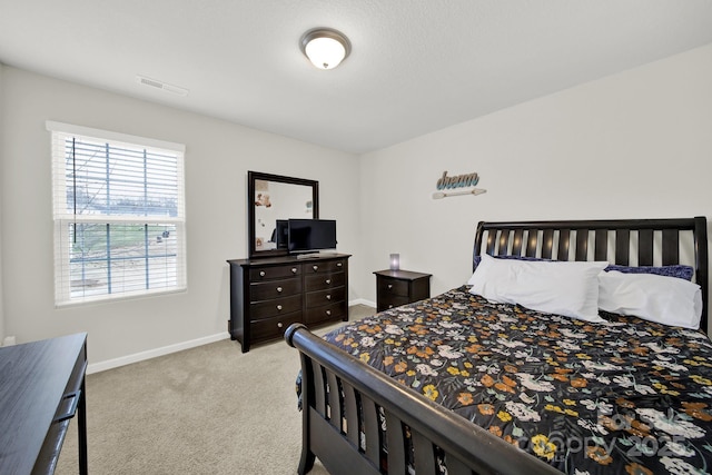 bedroom featuring visible vents, baseboards, and carpet flooring