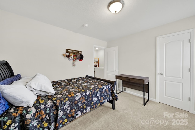 bedroom featuring baseboards and carpet