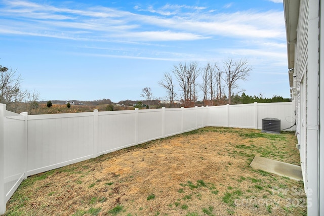 view of yard featuring central air condition unit and a fenced backyard