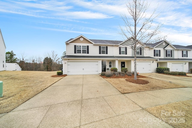 traditional-style house featuring driveway and an attached garage