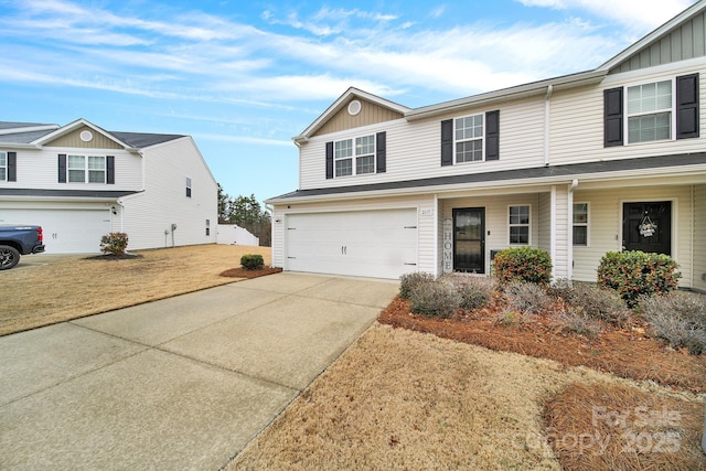 view of property featuring a garage and driveway