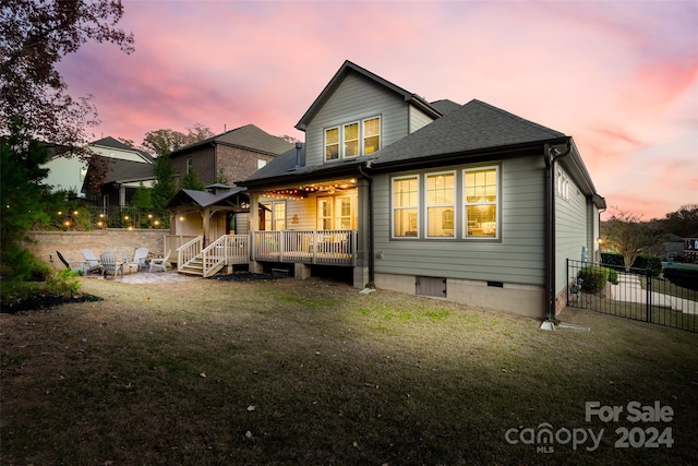 back house at dusk with a yard