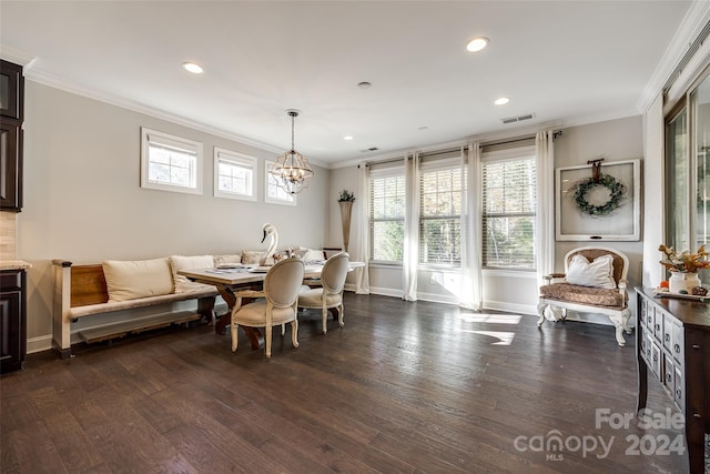 dining space featuring a healthy amount of sunlight, ornamental molding, dark wood-type flooring, and an inviting chandelier