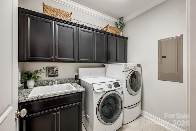 clothes washing area featuring electric panel, sink, cabinets, and washing machine and dryer