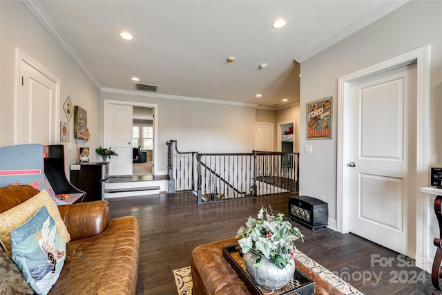 living room with dark hardwood / wood-style flooring and crown molding