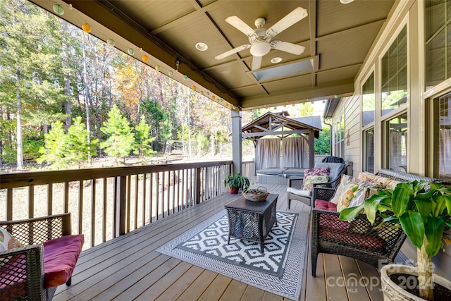 deck with ceiling fan and an outdoor hangout area