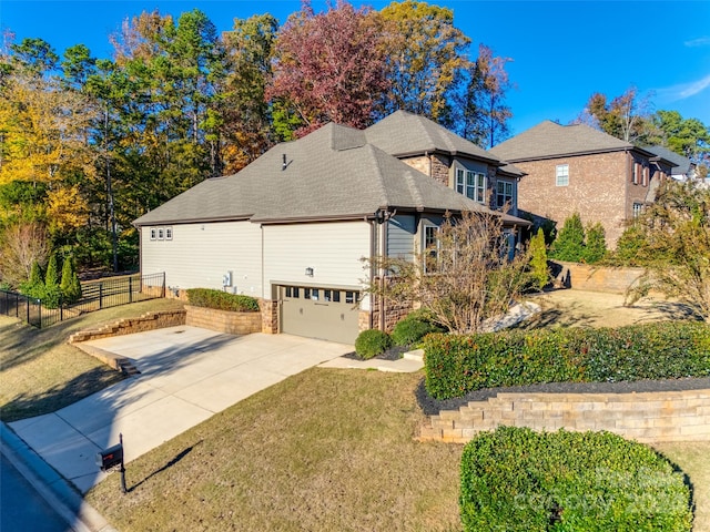 view of property exterior with a yard and a garage