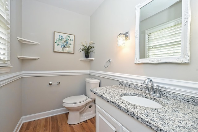 bathroom featuring hardwood / wood-style floors, vanity, and toilet