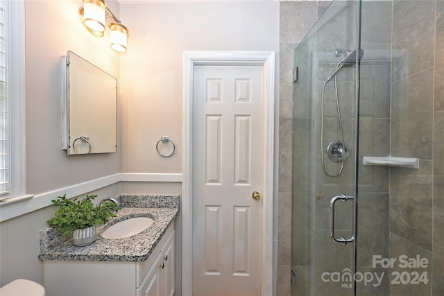 bathroom with vanity and an enclosed shower