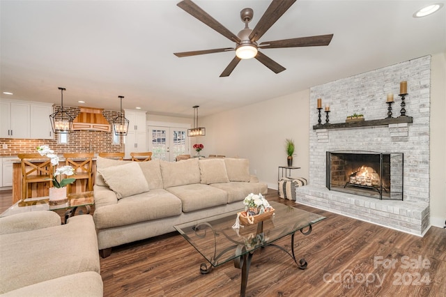 living room with ceiling fan, dark hardwood / wood-style flooring, a fireplace, and french doors