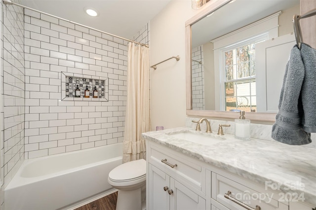 full bathroom featuring vanity, wood-type flooring, shower / bath combo, and toilet