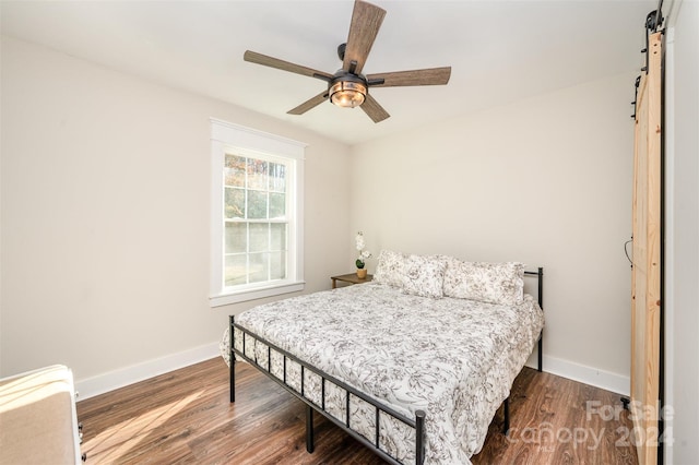 bedroom with dark hardwood / wood-style floors and ceiling fan