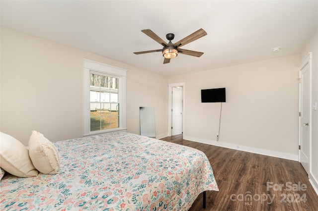 bedroom with ceiling fan and dark hardwood / wood-style floors