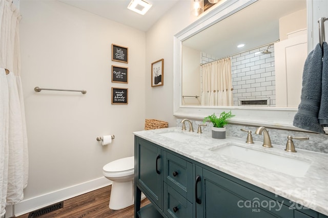 bathroom featuring vanity, hardwood / wood-style flooring, and toilet