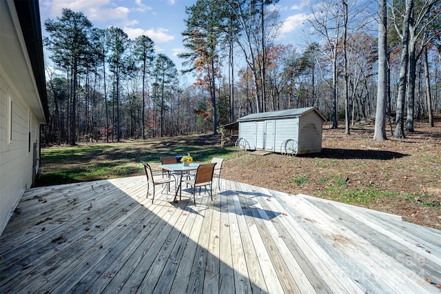 wooden terrace with a storage unit and a yard