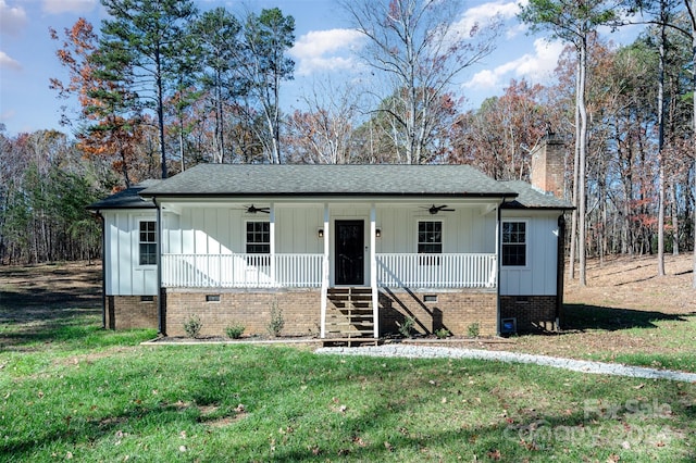 view of front of house featuring ceiling fan, a front lawn, and covered porch