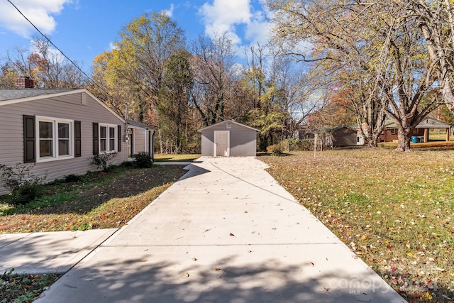 view of home's exterior with a lawn and a storage shed