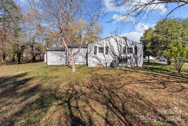 exterior space featuring a yard and central AC