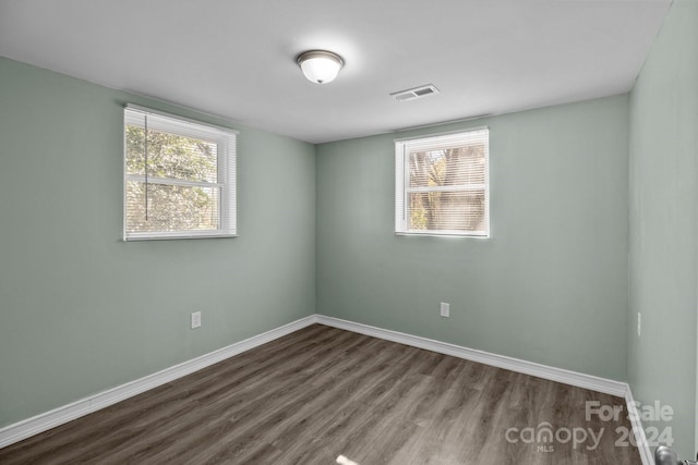 unfurnished room featuring hardwood / wood-style flooring