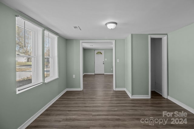 spare room featuring dark wood-type flooring