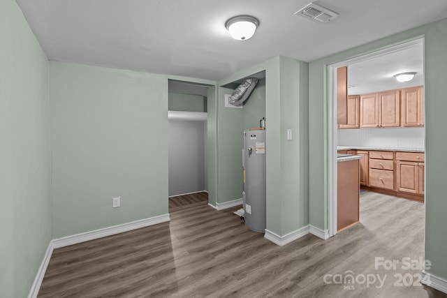 interior space featuring wood-type flooring and water heater